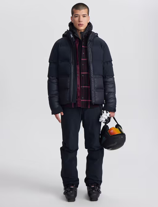 A man wearing a Aztech Mountain space black ski jackets