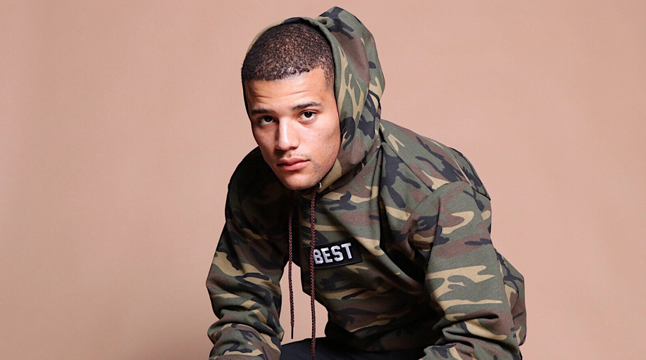 A man wearing army printed hoodie