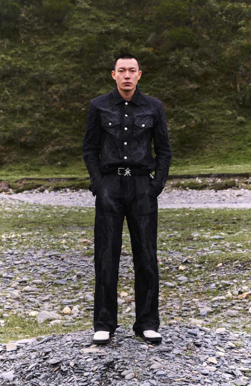A man wearing black denim shirt