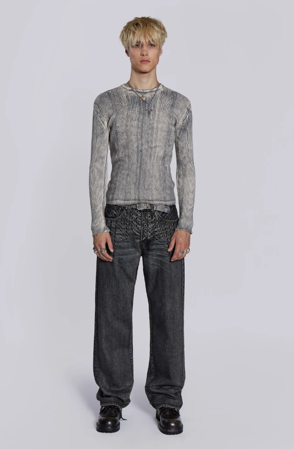 A man wearing a Jaded London tight-fitted cat print shirt and jeans