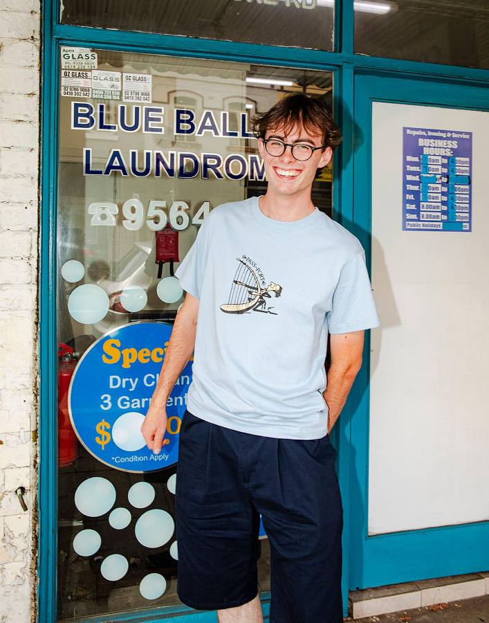 A man wearing PASS~PORT t-shirt in blue