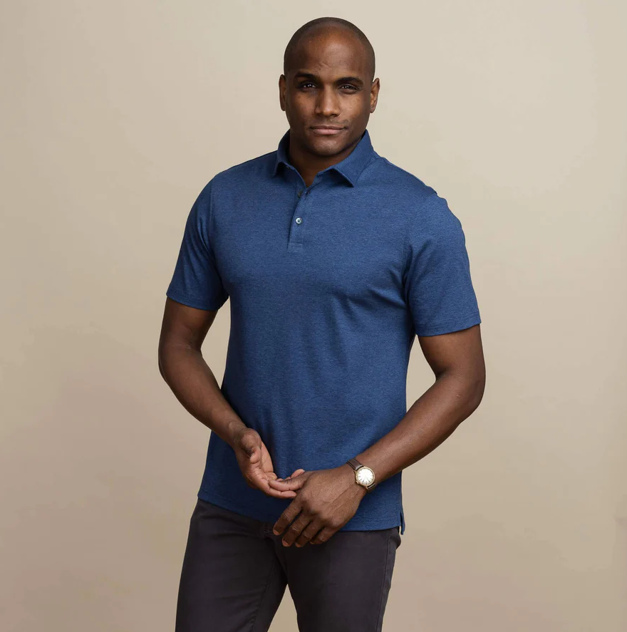 A man wearing the dark blue heather arlon knit custom polo by Ledbury