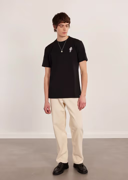 A man wearing a Percival black spaceman auxiliary t shirt