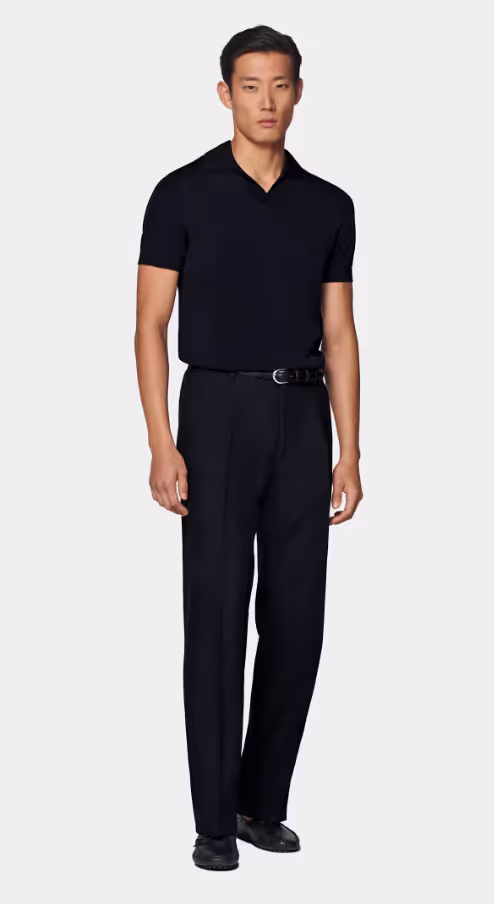 A man wearing a SuitSupply navy buttonless polo