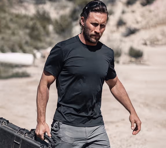 A man wearing a Ten Thousand black tactical shirt
