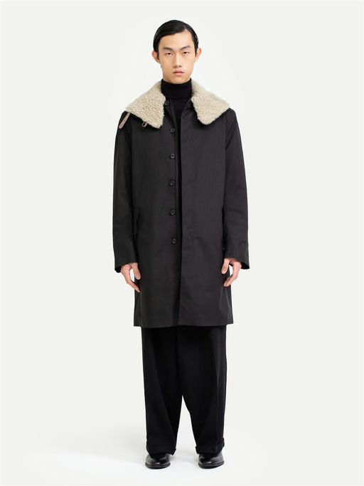 A man wearing Norwegian Rain black raincoat