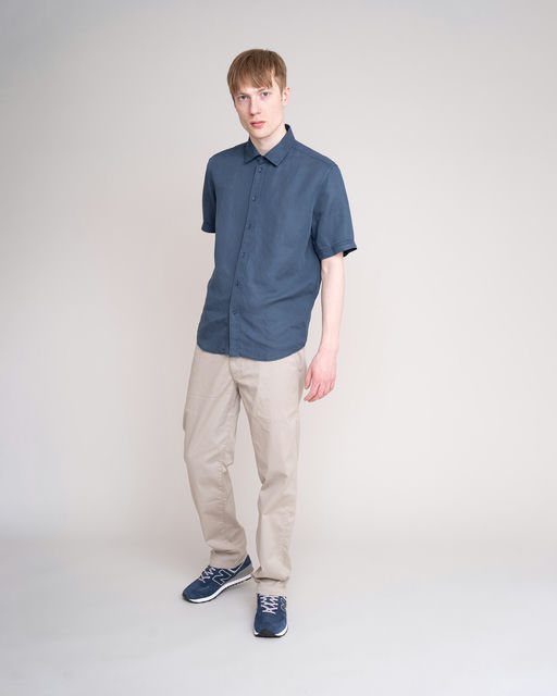 A man wearing JohnnyLove blue short sleeved shirt