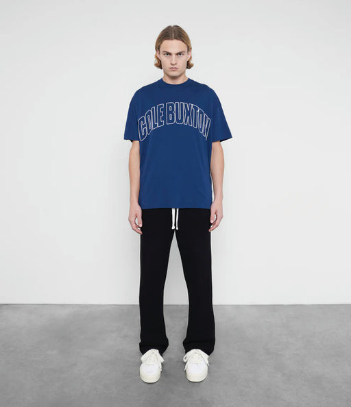 A man wearing Cole Buxton varsity arch outline  navy t-shirt