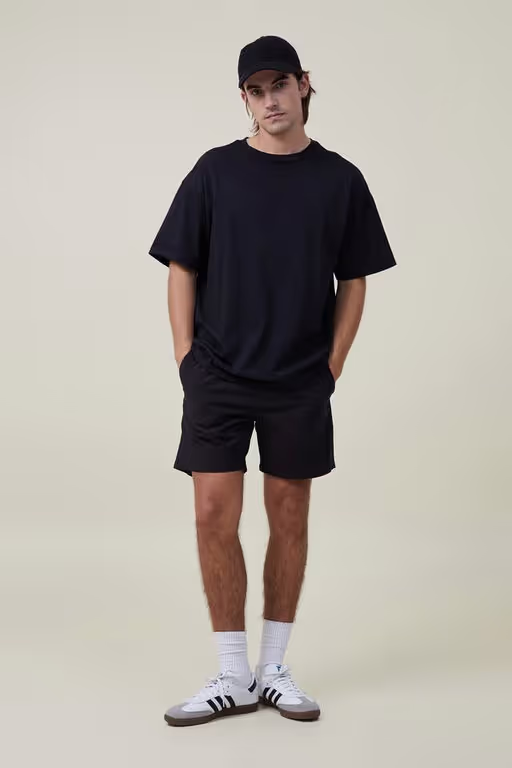 A man wearing Cotton On black easy short