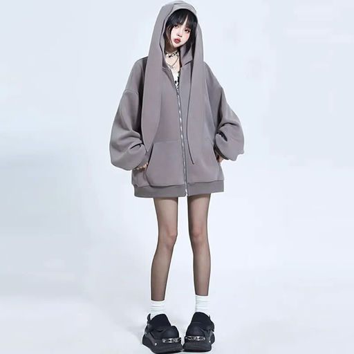 A woman wearing Modakawa long bunny ears pocket oversize zipper hooded grey sweatshirt