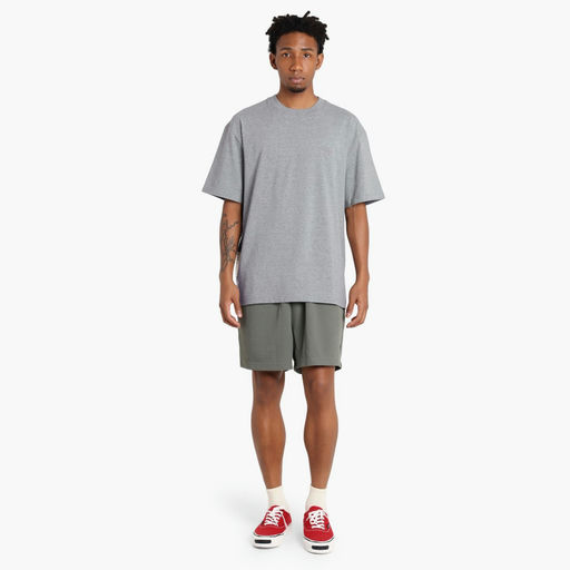 A man wearing Madness grey madness logo tee