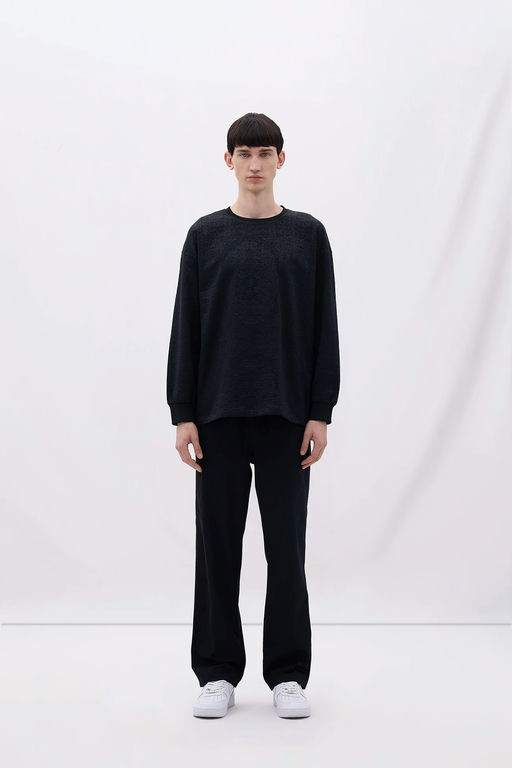 A man wearing Les Benjamins black long sleeve tee