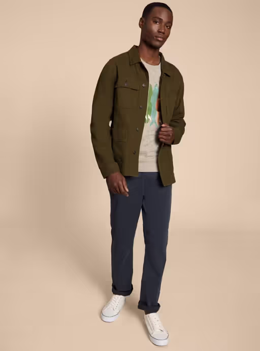 A man wearing White Stuff khaki green kynman workwear jacket