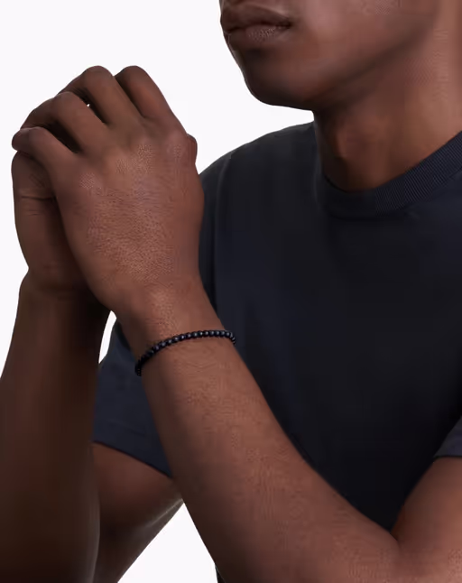A man wearing David Yurman spiritual beads bracelet