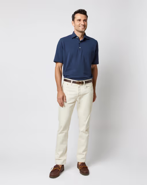 A man wearing Sid Mashburn navy short-sleeved polo