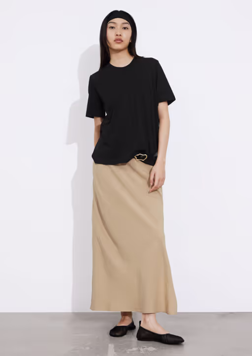 A woman wearing & Other Stories black crewneck t-shirt