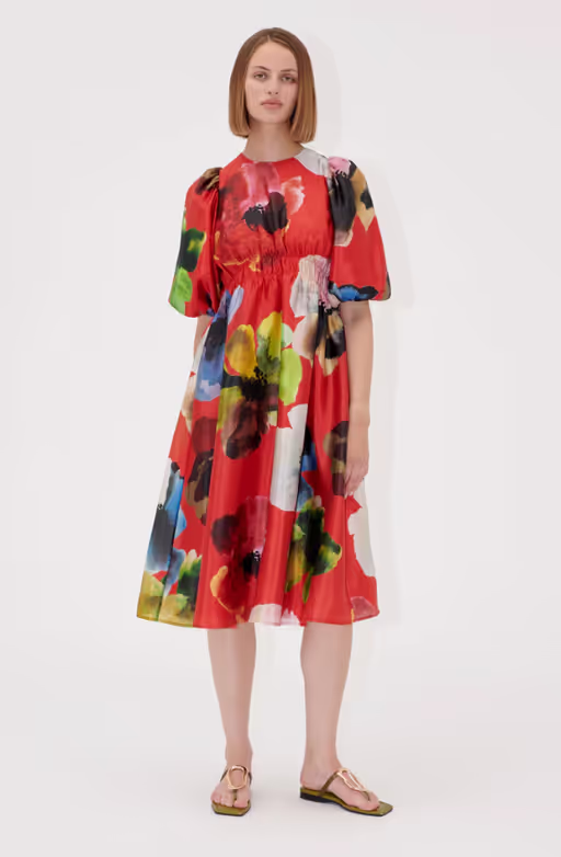 A woman wearing Stine Goya elasticated waist midi dress - bloom in red