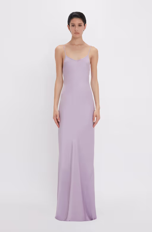 A woman wearing Victoria Beckham purple low back cami floor-length dress in petunia