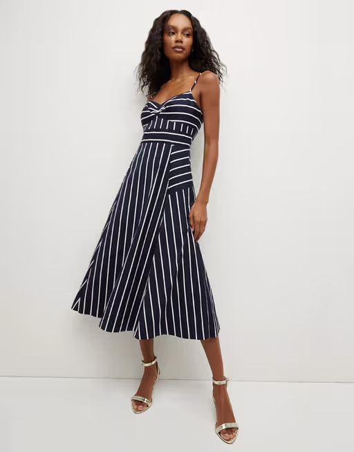 A woman wearing Veronica Beard blige striped dress