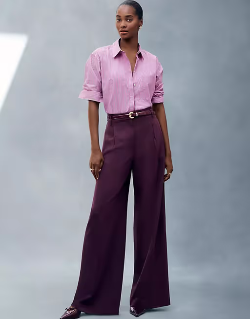 A woman wearing Ann Taylor pink stripe oversized shirt