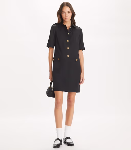 A woman wearing Tory Burch black camp dress