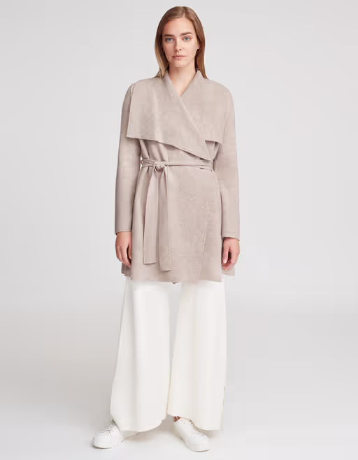 A woman wearing Cuyana wool cashmere sweater coat