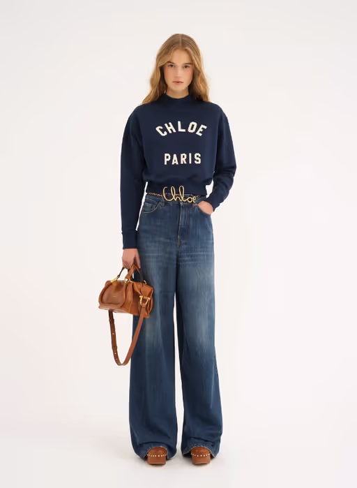 A woman carrying Chloé clay brown small paraty 24 bag in soft leather