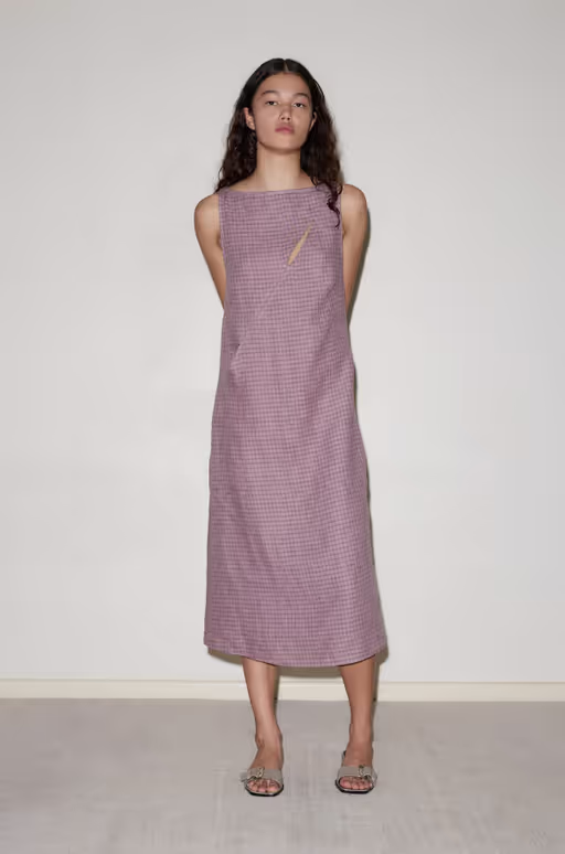 A woman wearing Deiji Studios high tie dress