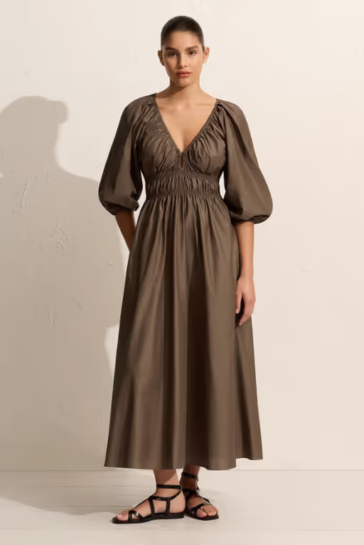 A woman wearing Matteau shirred plunge button dress