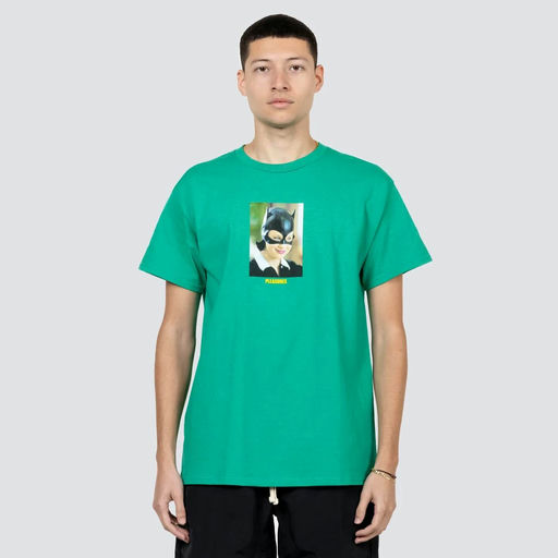 A man wearing a Pleasures green catwoman t-shirt