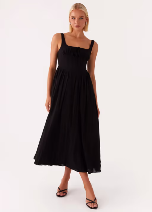 A woman wearing peppermayo​ peppermayo exclusive - pascuelle midi dress - black