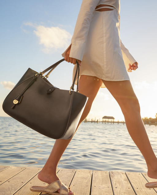A woman carrying Dooney and Bourke​ alto camilla handbag
