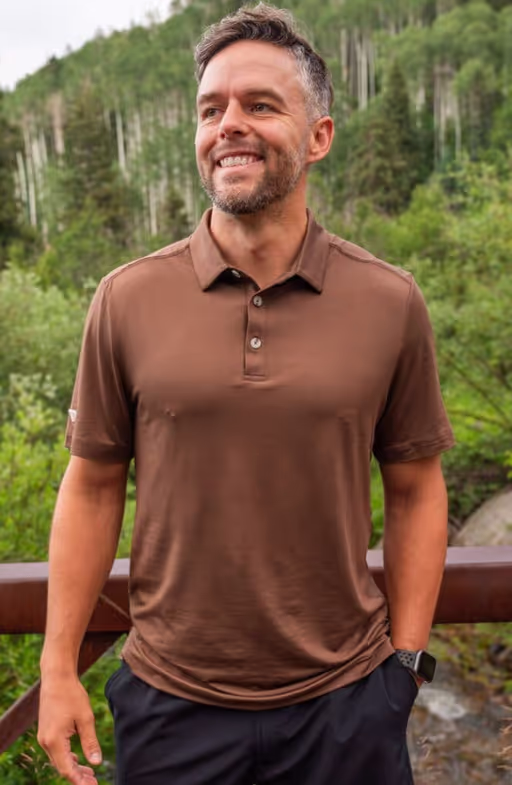 A man wearing BURLEBO performance polo - heather brown