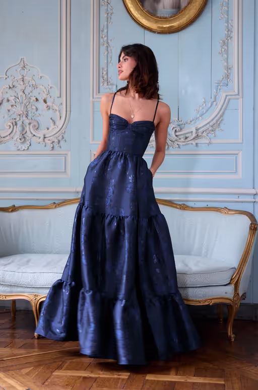 A woman wearing V. Chapman the lucetta dress in navy baroque floral