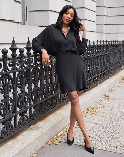 A woman wearing Express collared half button up mini portofino shirt dress