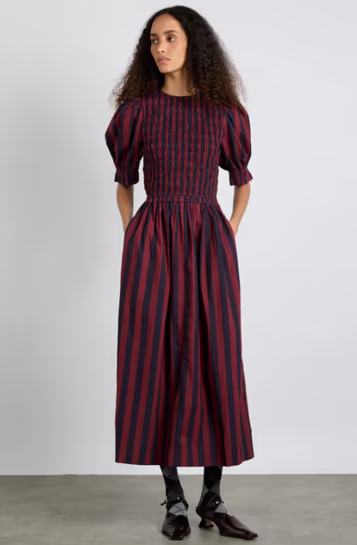 A woman wearing Damson Madder​ bluebelle midi dress - red/navy