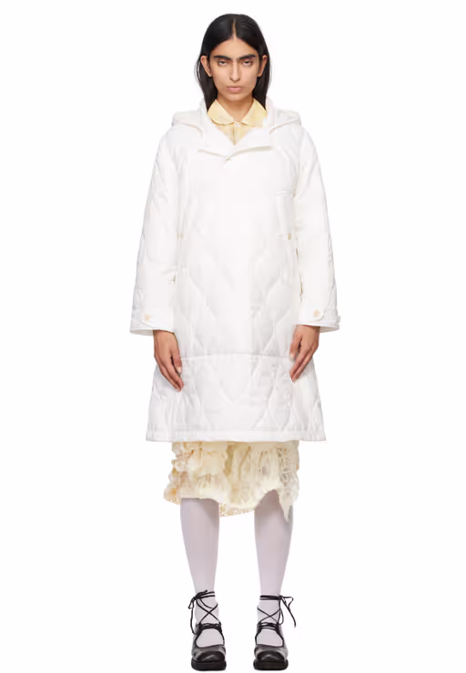 A woman wearing Tao Comme Des Garçons white taffeta quilting coat