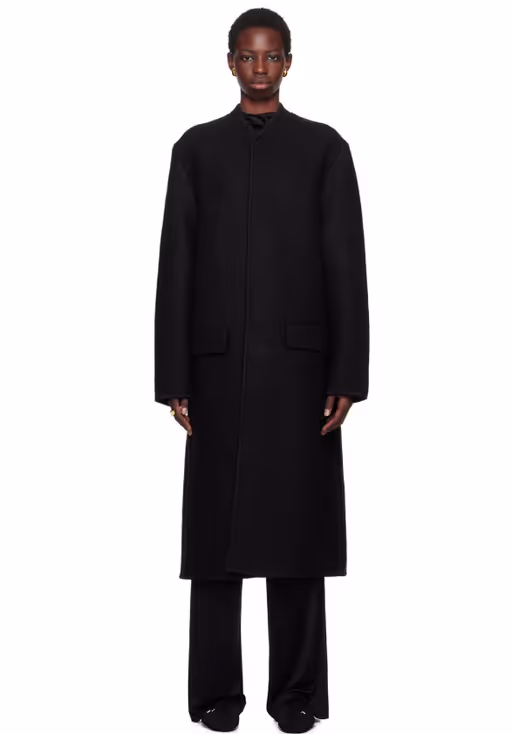A woman wearing Rier black walker coat