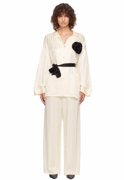 A woman wearing Sleeper off-white rose oversized satin pyjama set