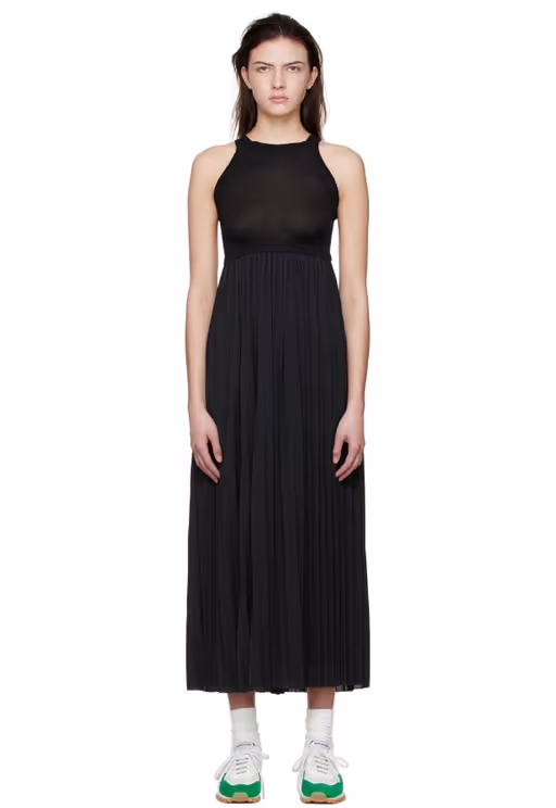 A woman wearing VAARA black polyester midi dress
