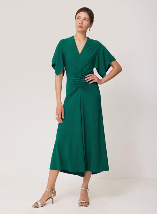 A woman wearing Jigsaw crepe flutter sleeve dress