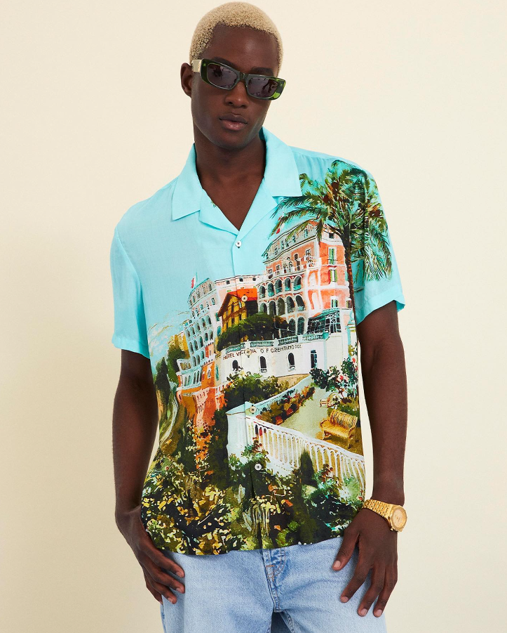 A man wearing a Camilla florida style button up shirt in blue