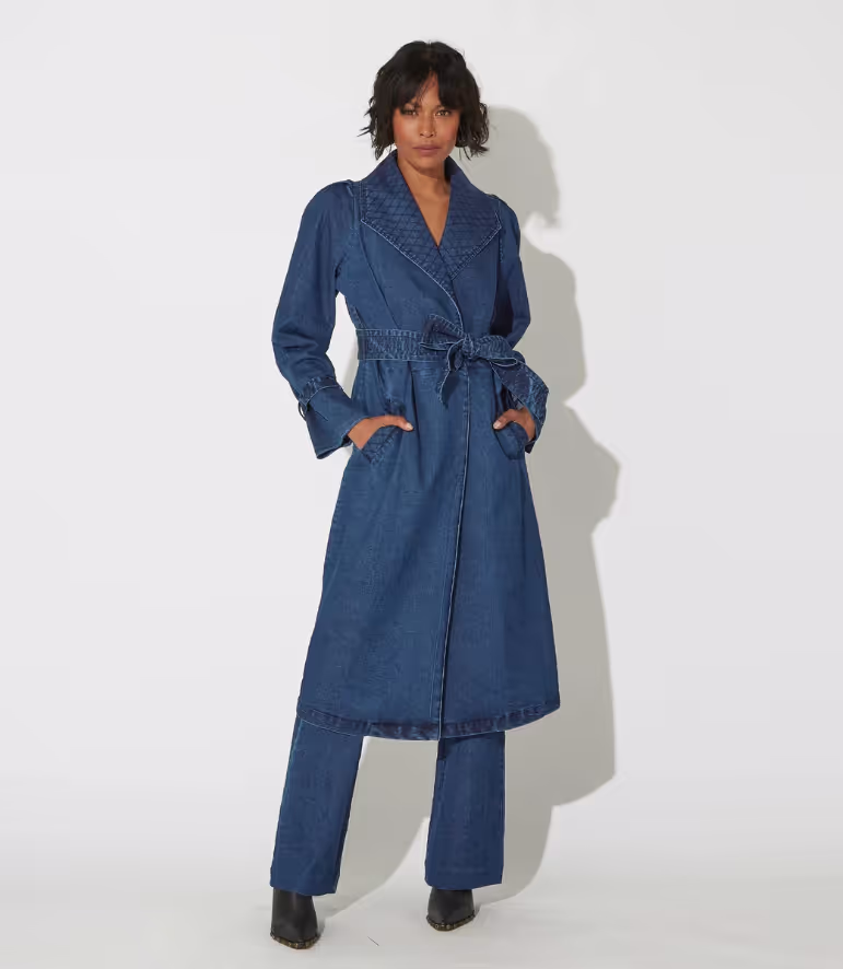A woman wearing a blue Cleobella suit dress and heels