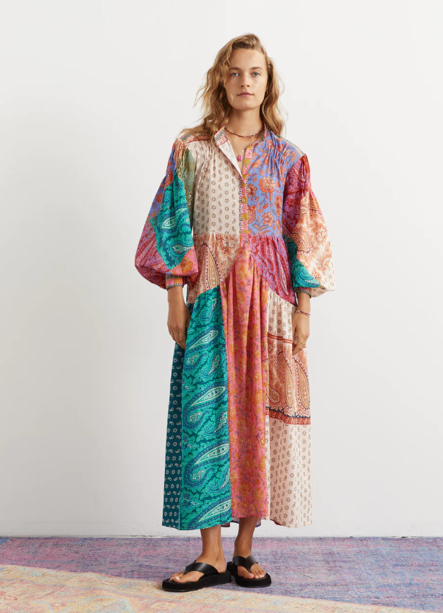 A woman wearing an oversize Boteh colorful dress
