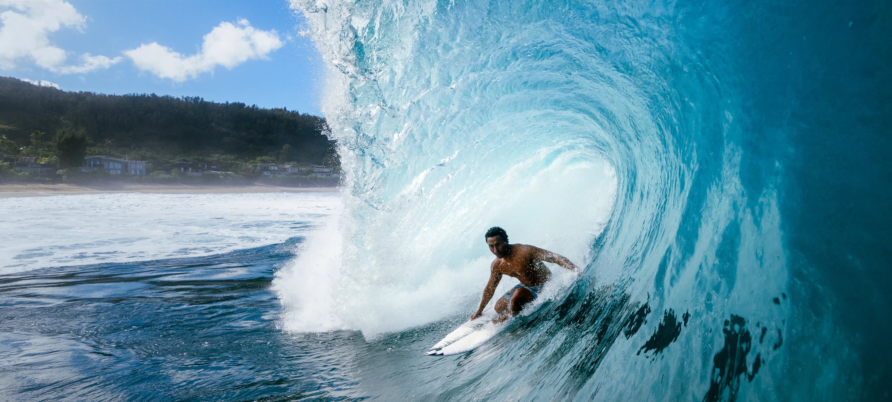 Hawaiian Island Creations surfer riding inside a barrelling wave