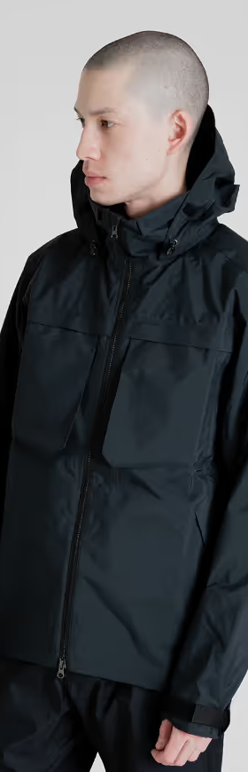 A man wearing a black Tilak winter jacket with matching pants
