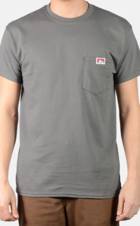 A man wearing a dark grey Ben Davis pocket t-shirt and brown pants
