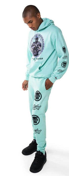 A man wearing a full light blue FUBU sweatsuit with graphics all over