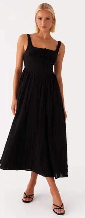 A woman wearing peppermayo​ peppermayo exclusive - pascuelle midi dress - black