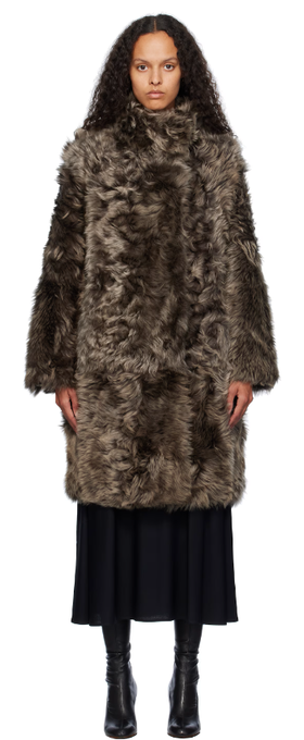 A woman wearing Yves Salomon brown toscana folk reversible shearling jacket